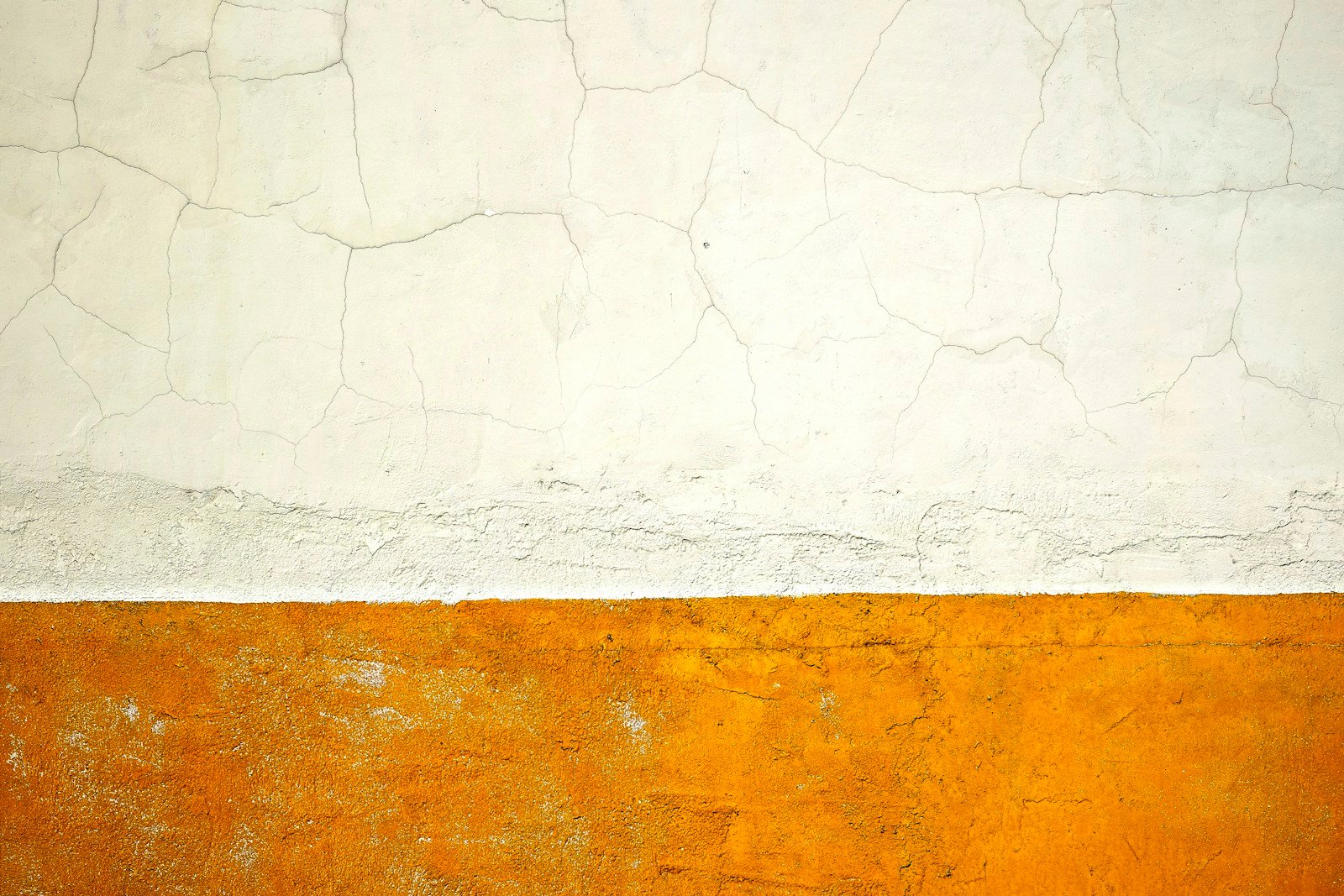 Peinture et enduit qui cloquent et s'écaillent sur un mur extérieur