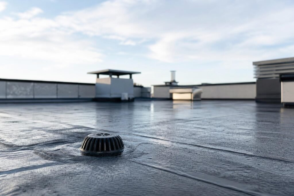 Toit plat recouvert d'une membrane d'étanchéité avec une évacuation d'eau pluviale
